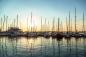 Preview: Fototapete MS-5-2775 „Boote & Schiffe“ als flache Draufsicht; maritimes Motiv mit Masten und Sonnenuntergang in warmen Farben